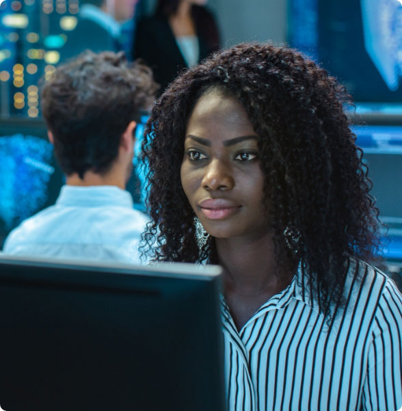 shipping technician viewing computer screen young woman of color