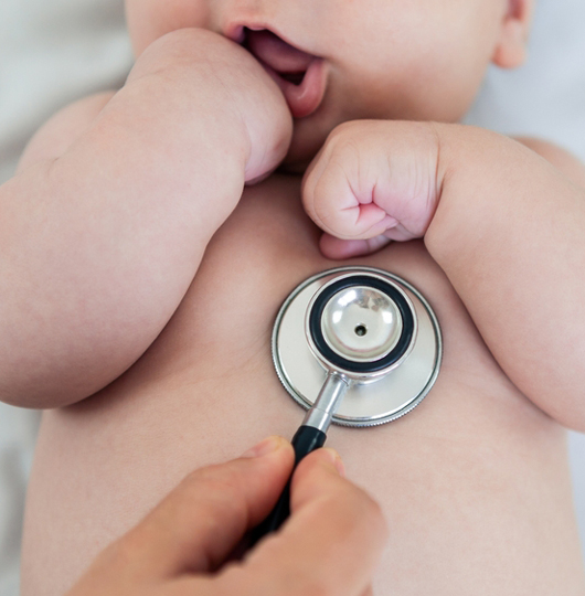 baby being checked with stethoscope