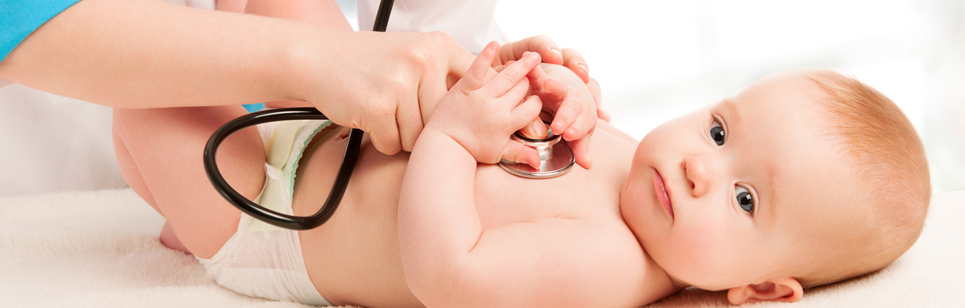 baby in diaper being checked with stethoscope